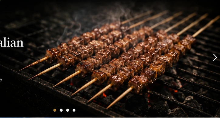 Arrosticini cooking over glowing embers